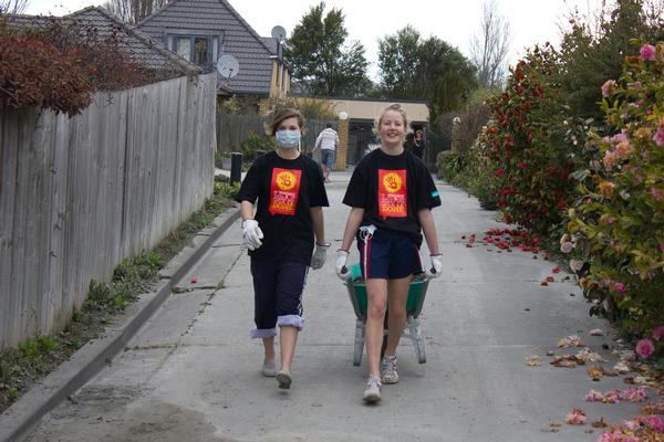 Working in the community earlier this year, two St Margaret's students assist the Rebuild Christchurch's "Let's Get It Done" initiative which saw volunteers help residents remove debris and dried silt from their properties.